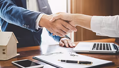 Real estate agent and customers shaking hands together celebrating finished contract after about home insurance and investment loan, handshake and successful deal.