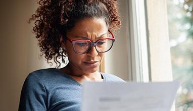 Concerned woman reading a letter