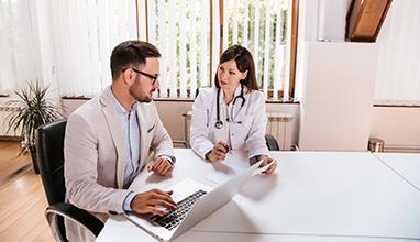 Female doctor discussing with manager.