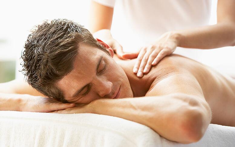 Young Man Enjoying Massage At Spa