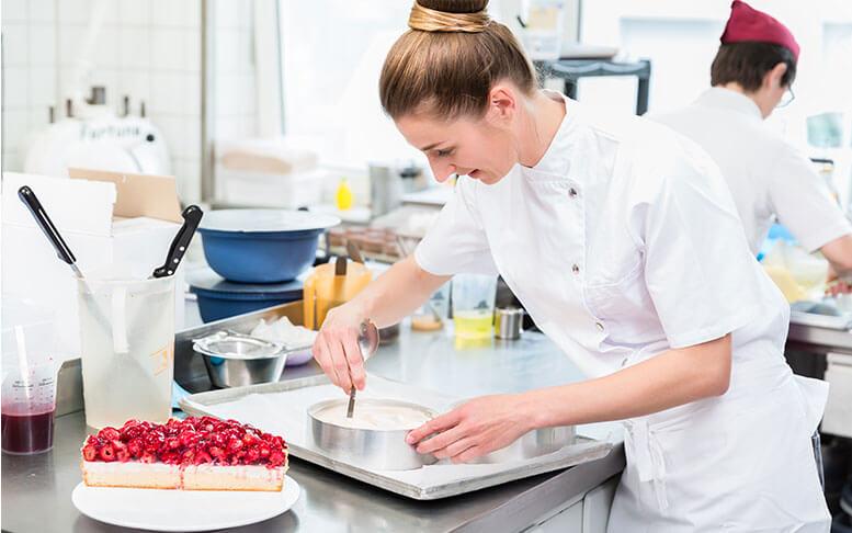 Women in pastry shop bakery making pies and cakes