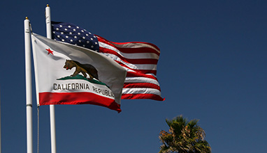 The California and American flags waving in the wind