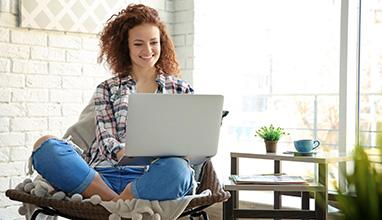 Smiling woman working on her laptop