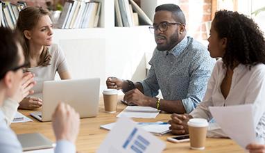 Group of business people discussing at an office table