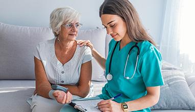 Woman nurse taking the blood pressure of an elderly woman 