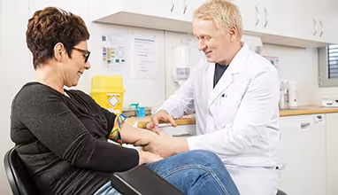 Doctor giving a shot to a patient in doctors office