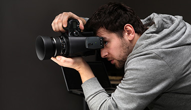 Male photographer taking a photo in a studio