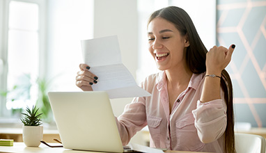Smiling woman looking at her admission letter