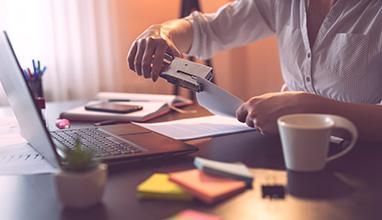 Woman stapling papers together