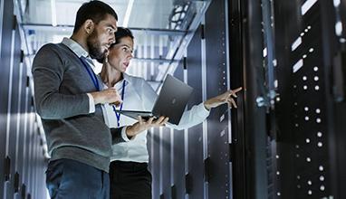 Man and woman system administrators on a laptop