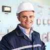 Portrait of a male engineer wearing a hard hat at a control room