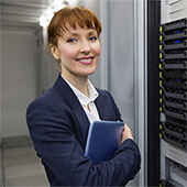 A professional woman standing next to a server