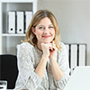 Professional woman with a laptop sitting at her desk