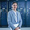 Professional woman holding a laptop in a server room