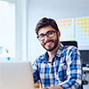 Male programmer using a laptop at his desk