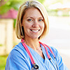 Woman wearing medical scrubs and a stethoscope around her neck
