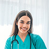 Woman wearing medical scrubs at a lobby