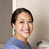Woman wearing medical scrubs using a photocopier