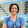 Woman wearing medical scrubs and a stethoscope around her neck