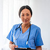 Woman wearing medical scrubs at a lobby