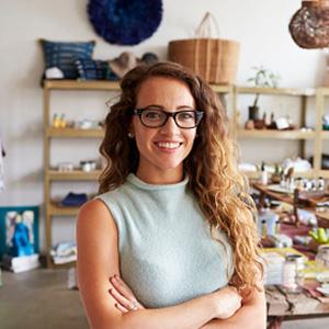 A woman standing inside her store